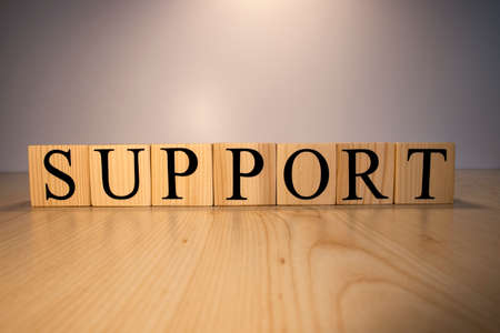 Support text from wooden cubes. Photos were taken on the wooden desk.の写真素材