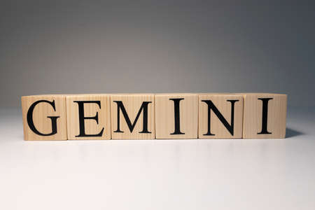 Gemini word on wooden cubes on white background. Photographed in the studio and in spot light. Zodiac or star signs consists of 12 horoscopes.の写真素材