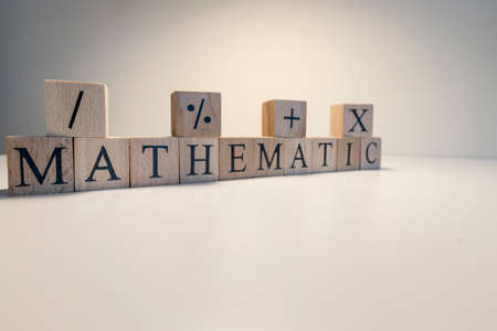 Education concept. Education and math relation. Mathematics, astronomy, economy words with letters from wooden cubesの写真素材