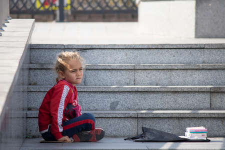 Istanbul, Turkey - October-27.2019: Little blonde girl homeless and begging. In bad condition and begging on the sidewalk.のeditorial素材