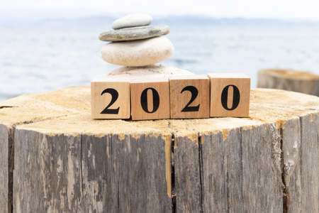 2020 text on wooden cubes on tree stump. Close up.の写真素材