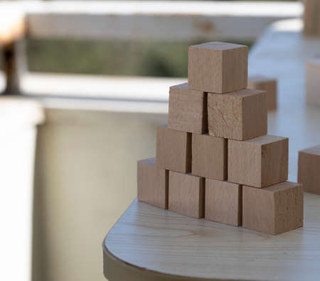 Building from wooden cubes and rods. A photo was taken on the desk.の写真素材