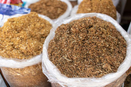 Dried tobacco sold in bags in the street. Photographed in Turkey. Various tobaccos side by side.