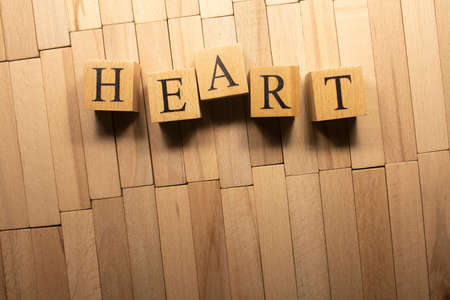 The word heart was created from wooden cubes. Health and life. Close up.の写真素材