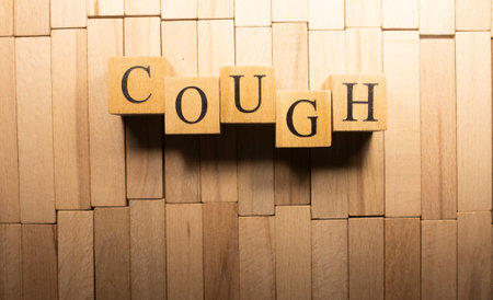 The word Cough was created from wooden cubes. Health and life Close up.の写真素材
