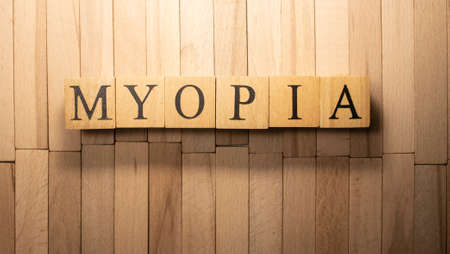 The word Myopic was created from wooden cubes. Health and life. Close up.の写真素材