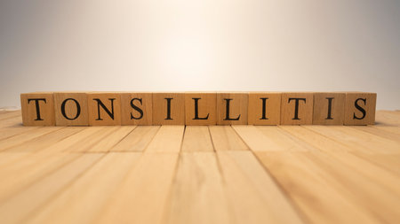 The word tonsillitis was created from wooden letter cubes. Illness and health . close up.の写真素材