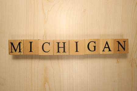 The word Michigan was created from wooden letter cubes. Cities and words. close up.の写真素材