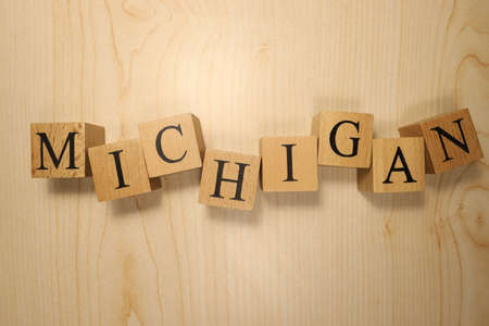 The word Michigan was created from wooden letter cubes. Cities and words. close up.の写真素材