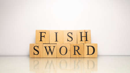 The name Swordfish was created from wooden letter cubes. Seafood and food. close up.