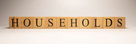 The name Households income was created from wooden letter cubes. Economics and finance. close up.