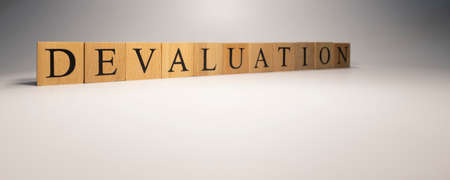 The name Devaluation was created from wooden letter cubes.の写真素材
