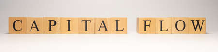 The name capital flow was created from wooden letter cubes. finance and economy. close up.の写真素材