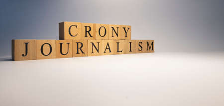 Crony Journalism was created from wooden cubes. News and journalism concepts. close up.の写真素材