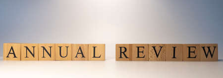 The word Annual review was created from wooden cubes.Close-up.の写真素材