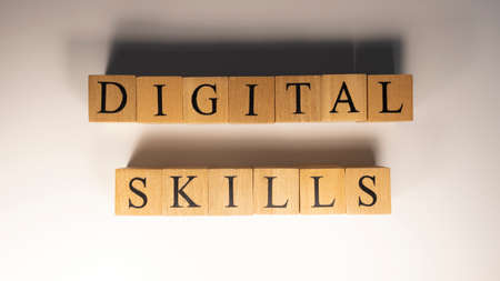 The word digital skills was created from wooden cubes. Education and work. close-up.の写真素材