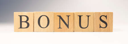 The word BONUS was created from wooden cubes. Education and business. close-up.の写真素材