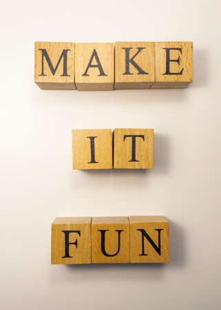 The word Make it fun was created from wooden cubes. entertainment and education concept. close upの写真素材