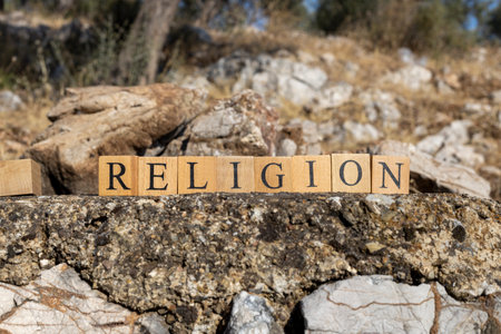 The Word Religion was created from wooden cubes. Photographed on the wall. close-up.の写真素材