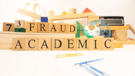 Academic fraud was created from wooden cubes. Education concept. Close-up.の写真素材