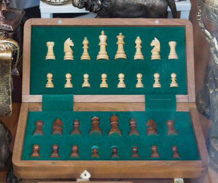 Retro wooden chess set on a furry hide, top view of the chessboard. Closeup.