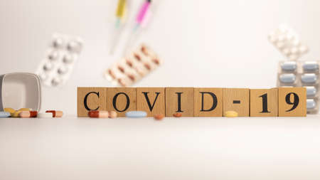 covid -19 disease was created from wooden cubes. Diseases and health.の写真素材