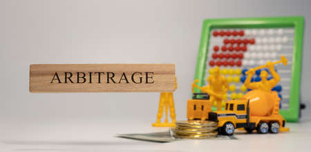 arbitrage sentence written on wooden surface. economy and conceptの写真素材