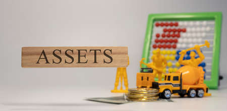 Asset sentence written on wooden surface. Economy and concept.の写真素材