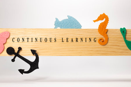 Continuous learning written on wooden patterned surface. Education and child psychology.の写真素材