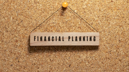 financial planning written on wooden surface. Wooden concept. Work and education, personal development.の写真素材