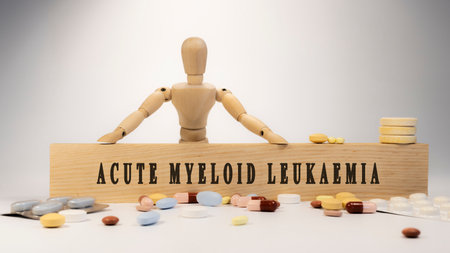 Acute myeloid leukaemia written on wooden surface. Wooden man and medicine conceptの写真素材