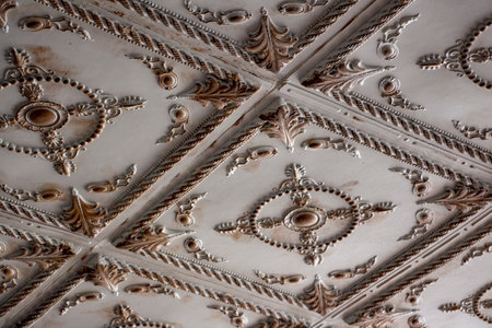 Detail of the ceiling of an antique building. Decorative antique design pattern. Details of the interior of the mansion ceilingの写真素材