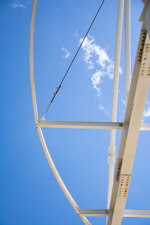 Detail of the structure of a steel structure against the blue sky.