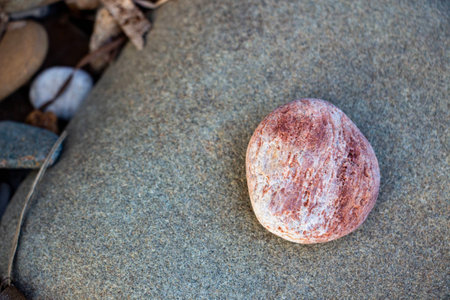 Stones and pebbles on the beach in the summer. Round stone on the beach, close up. Nature background with stones.の写真素材