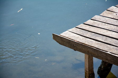 Wooden pier on the lake with river. Nature background. Wooden pier on the lake in the park with...
