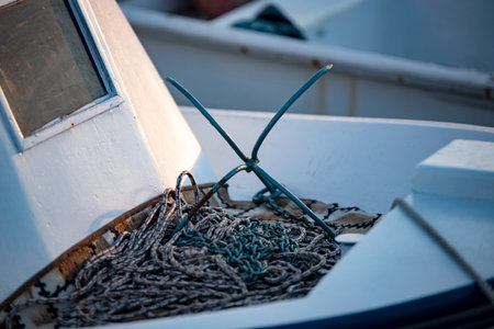Detail of fishing boat with anchor and rope. Selective focus.