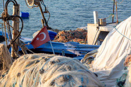 Flag of Turkey on a fishing boat in the port. Turkish flag on a boat in the sea.