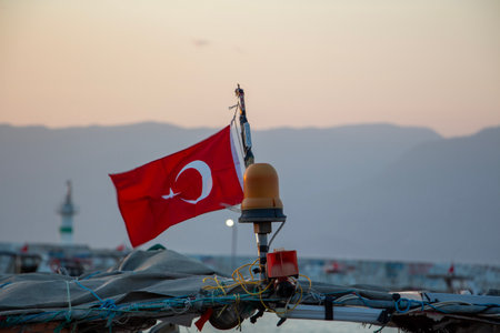 Flag of Turkey on a fishing boat in the port. Turkish flag on a boat in the sea.の写真素材