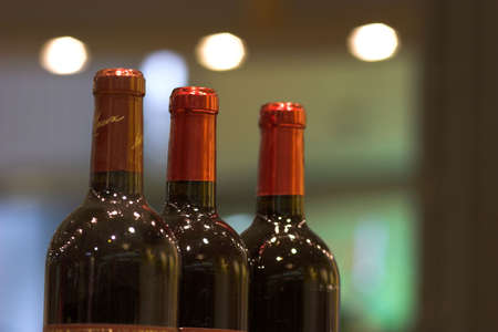 three bottles of red wine at a bar. blurring backgroundの写真素材