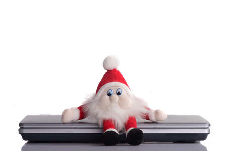 santa claus closed the pc and goes christmas. White background.の写真素材