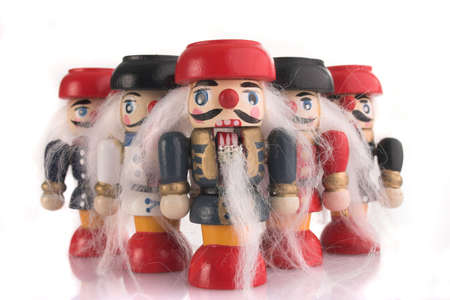 little wooden nutcrackers in a fanlike parade, isolated white background
