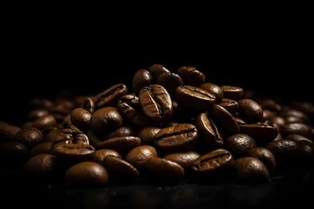Coffee beans on a dark background. International Coffee Day, fresh and bright wallpaper as concept of ingredient for tasty hot drinkの写真素材