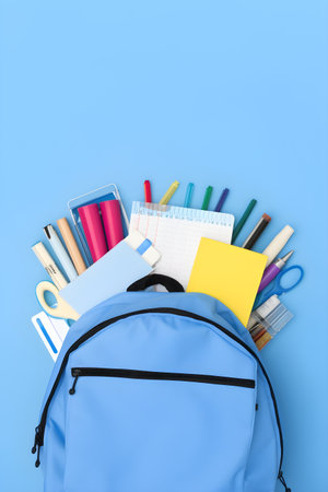 Blue backpack with school stationery on blue background, education day, international education day, Back to school concept,  with copyspace, for banner background.の素材