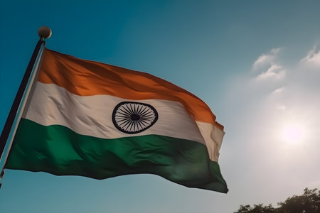 India flag waving in the wind against the blue sky with sun rays, celebrates January 26th Republic day, August 15th independence day concept, for banner background.の素材