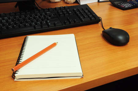 Notepad, pencil, Calculator and computer set on office deskの写真素材