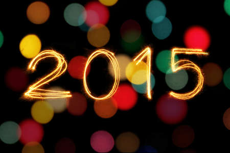 2015 written with Sparkling figures and colorful blur bokeh backgroundの写真素材