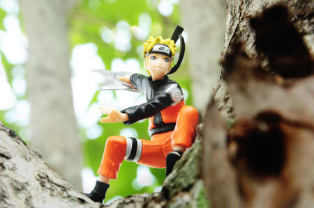 BANGKOK - DECEMBER 07, 2014 : Figure of Naruto animation is throwing shuriken on the tree on December 07, 2014 at Bangkok, Thailand.のeditorial素材