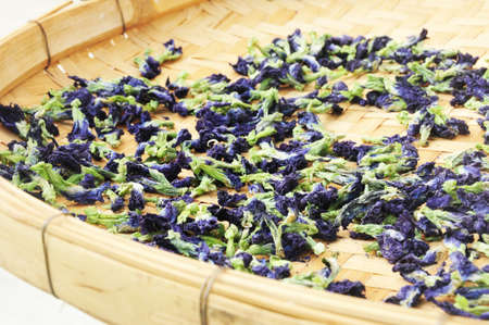 Dried butterfly pea herb flowers in bamboo basketのeditorial素材