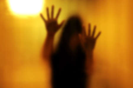 Woman behind the matte glass. Blurry hand and body figure abstraction.の写真素材