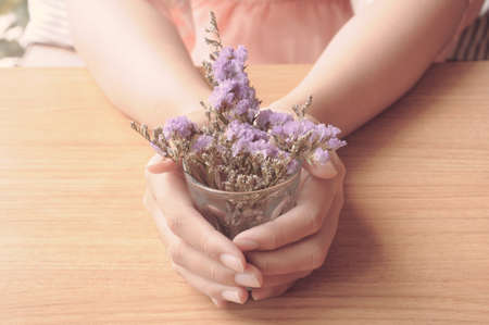 Woman hands holding lavender flowers in vintage toneの写真素材